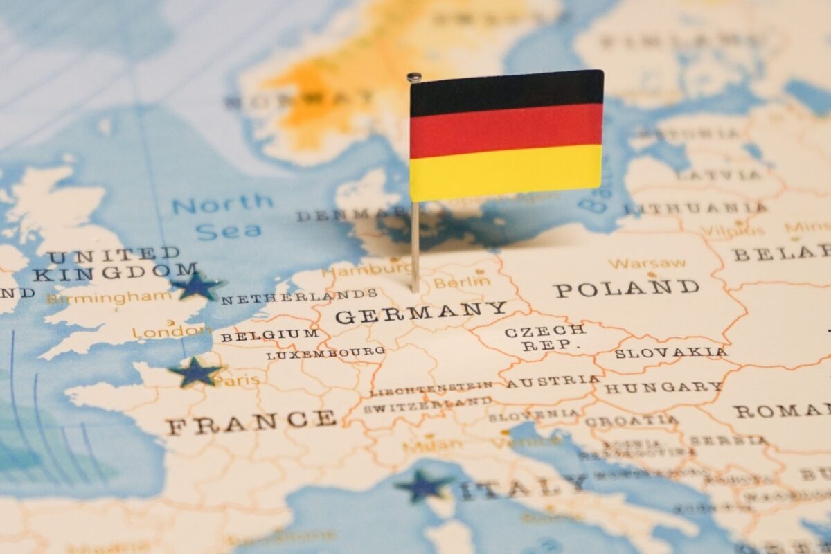 Map with a tiny German flag pinned in Germany