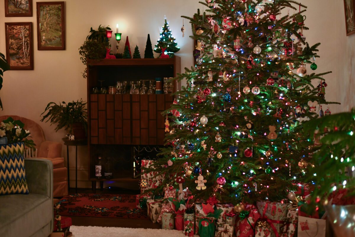 Living room with Christmas tree, mid-century decor.