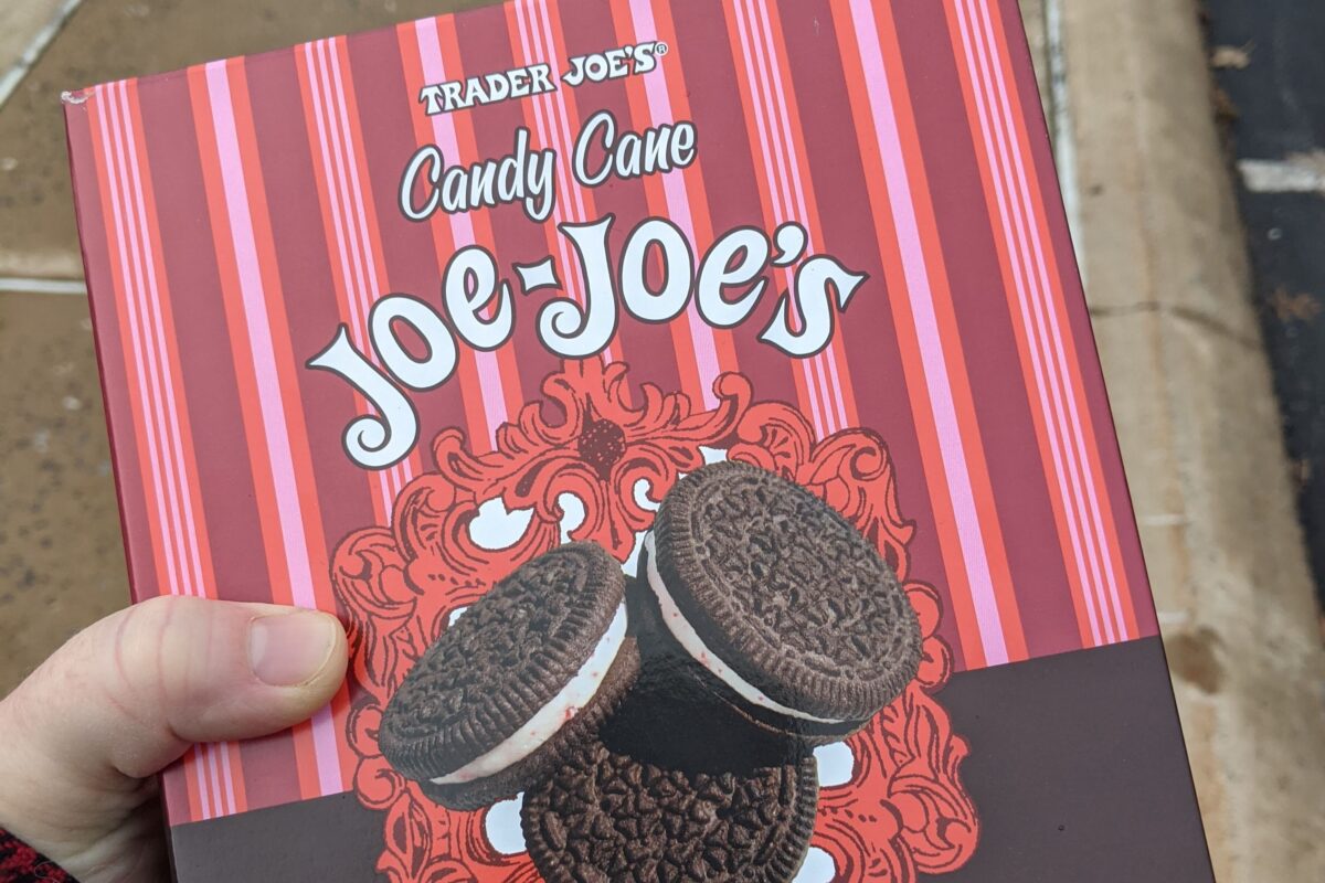 Woman's hand holding a box of Trader Joe's Candy Cane Joe-Joe's
