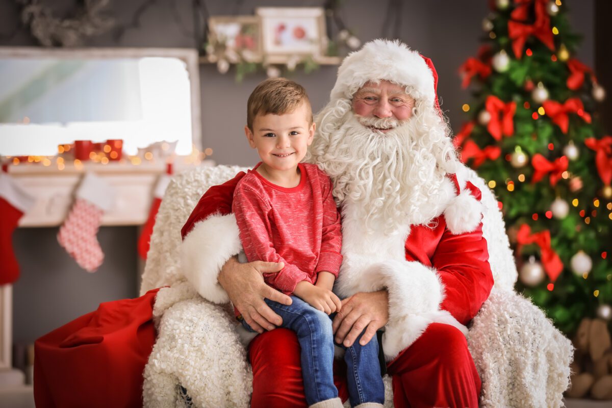 Santa with a small boy sitting on his lap