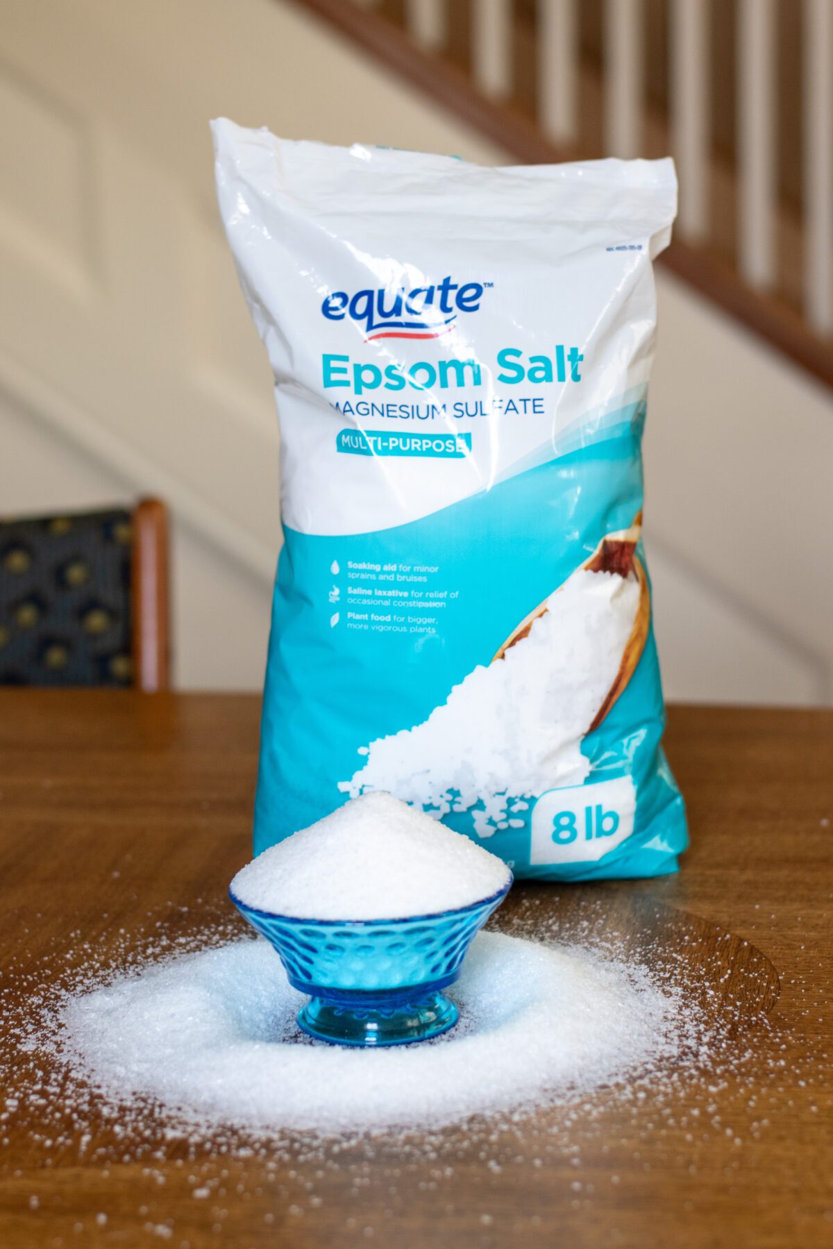 Bag of Epsom salt next to dish filled with Epsom salt.