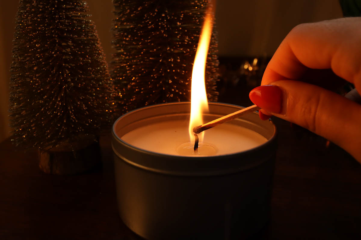 woman's hand lighting  candle