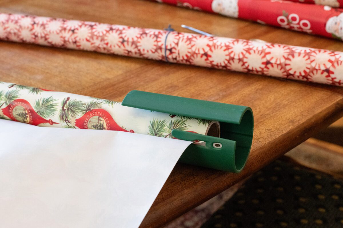 Little Elf paper cutter positioned on a  roll of wrapping paper