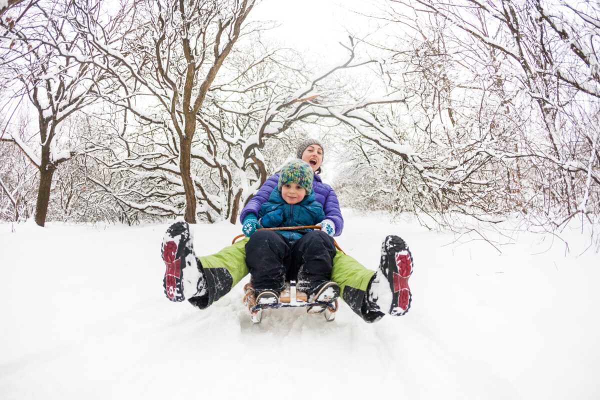 Mother and child sledding