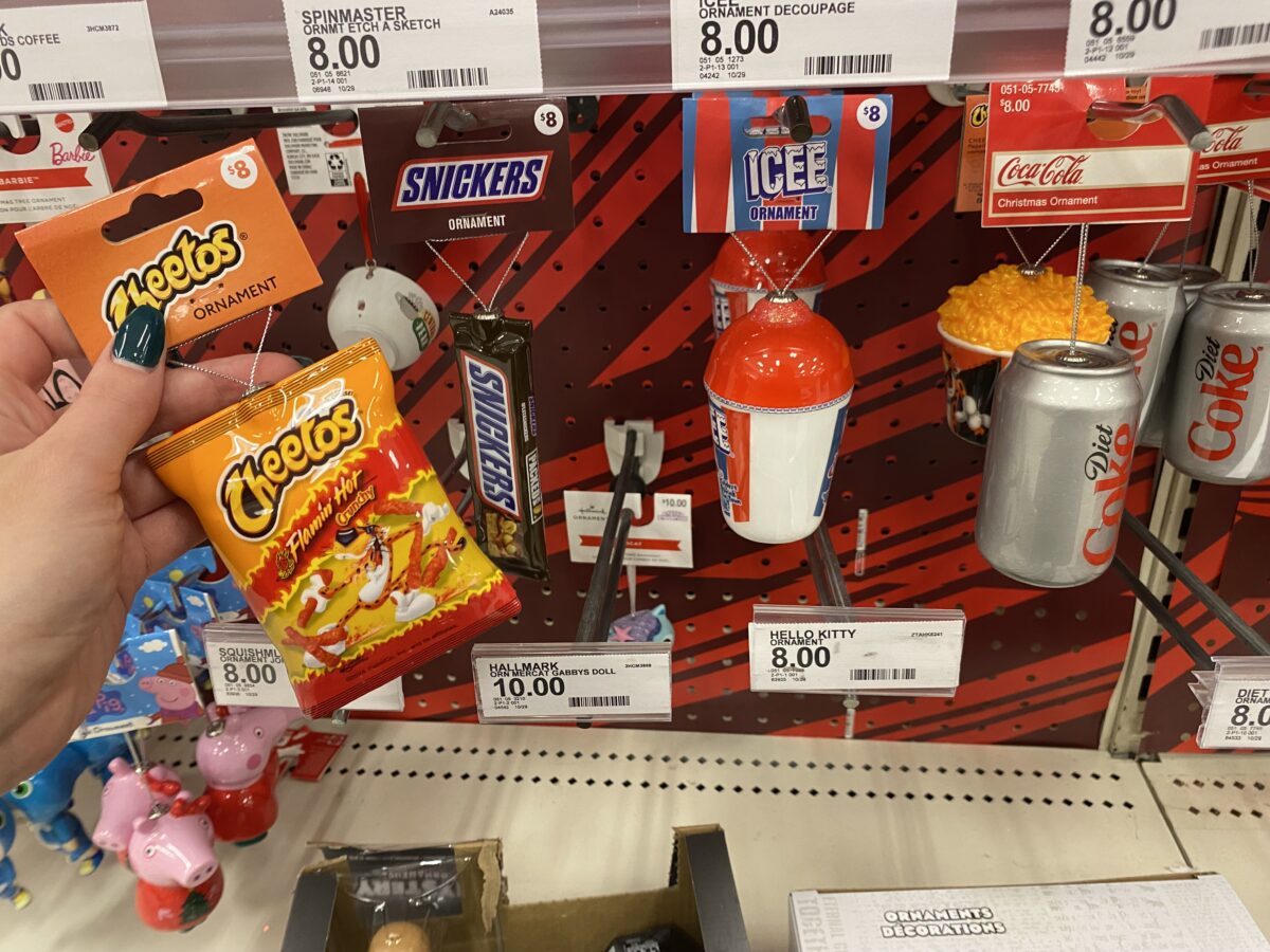 Woman's hand holding a Cheetos ornament