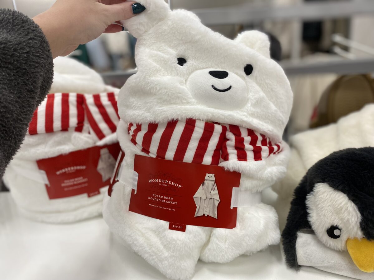 Woman's hand holding a polar bear hooded blanket