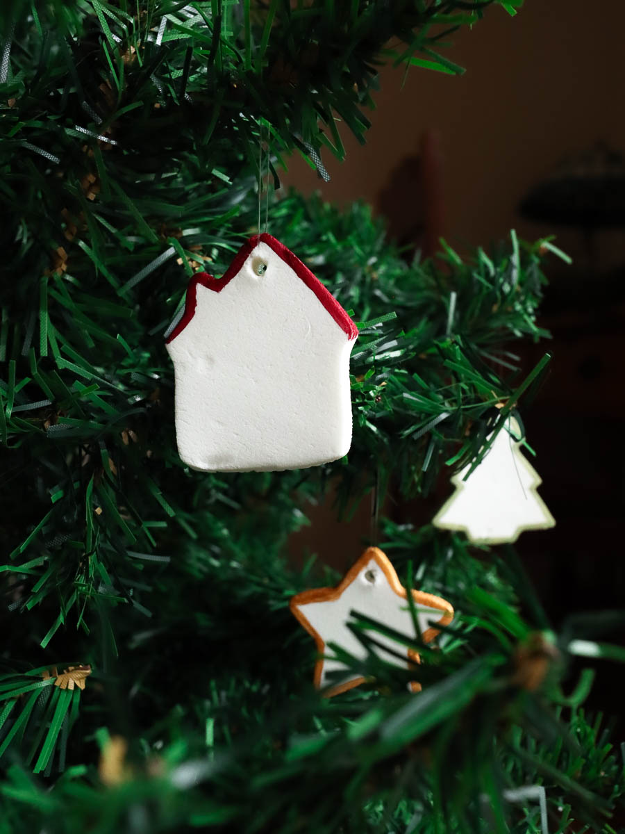 Baking soda dough Christmas ornaments hanging on a Christmas tree. 