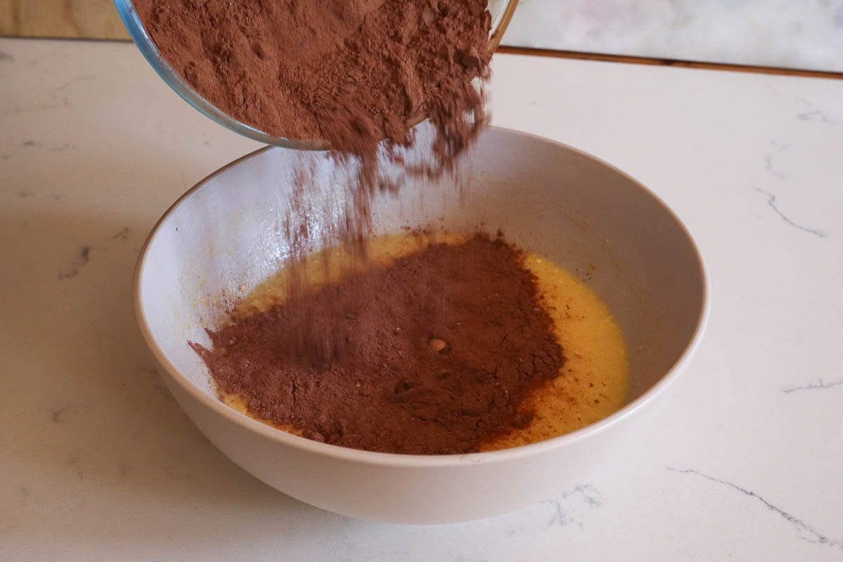 Mixing powdered cocoa with butter. 