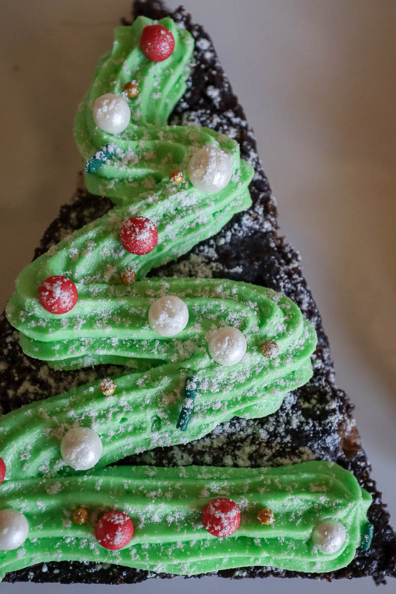 Close up of a brownie decorated to look like a Christmas tree. 