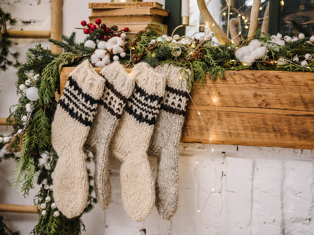 Rustic stockings hung by a fireplace