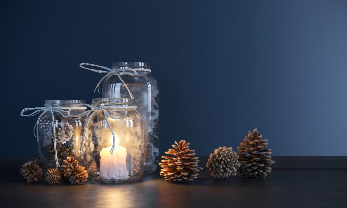 Mason jars filled with pine cones and a candle