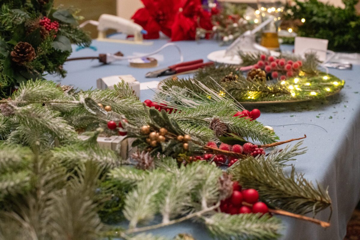 Table covered in wreath making supplies