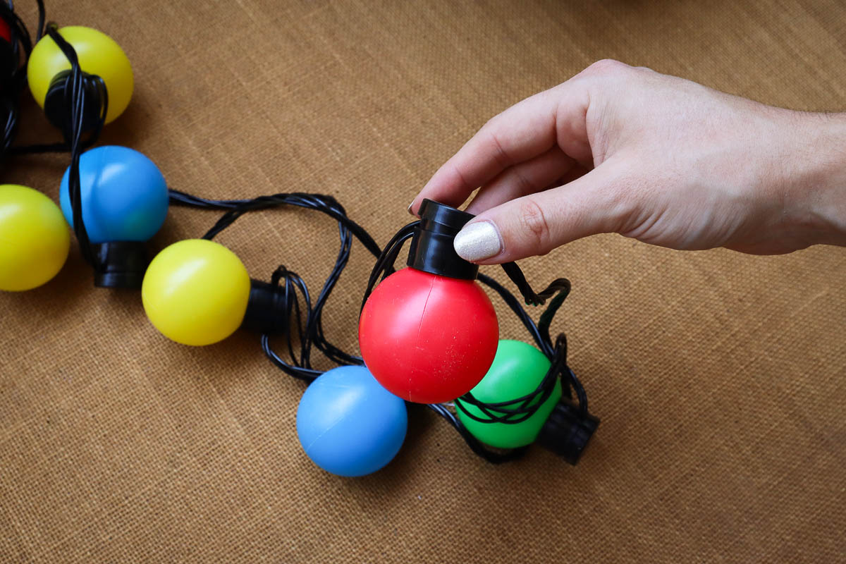 Woman's hand holding Christmas lights