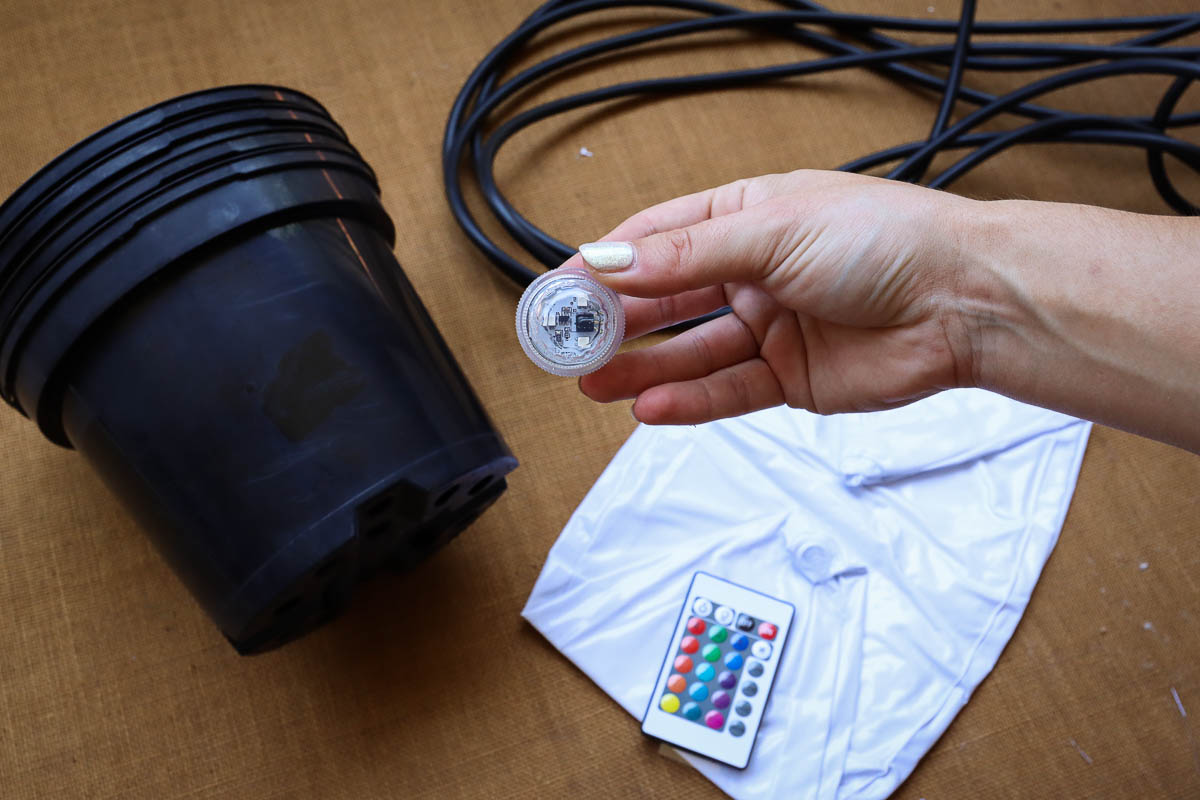 Woman's hand holding LED light that lights up beach ball