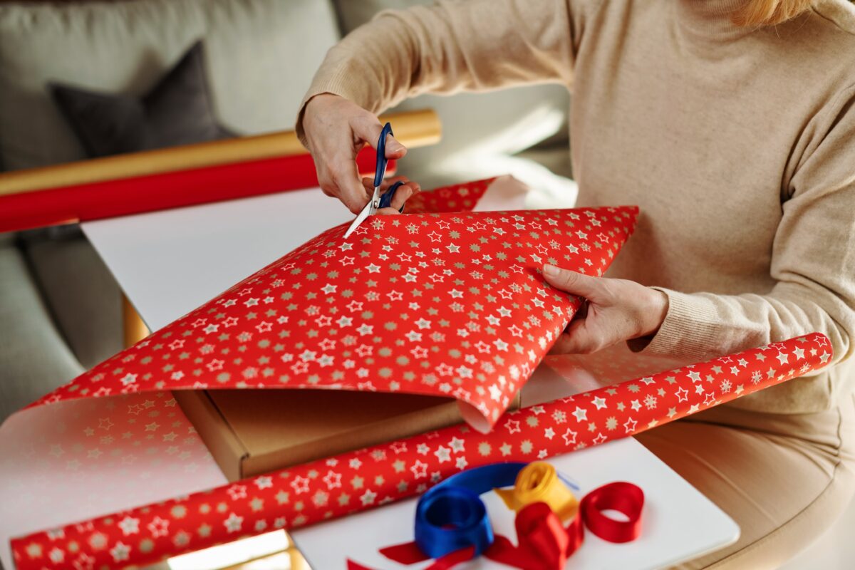 Woman cutting Christmas wrapping paper