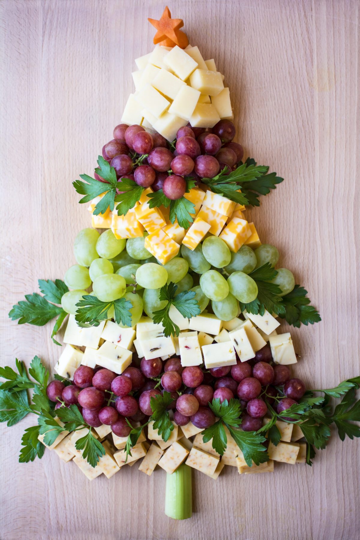 Grapes and cheese arranged in the shape of a Christmas tree. 